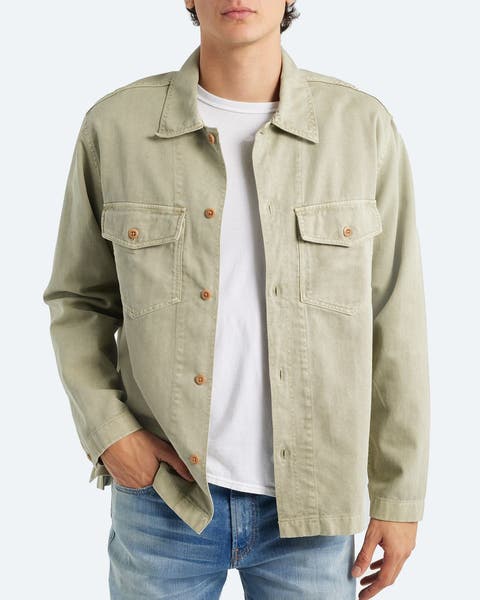 A man wearing a light sage green shirt jacket.