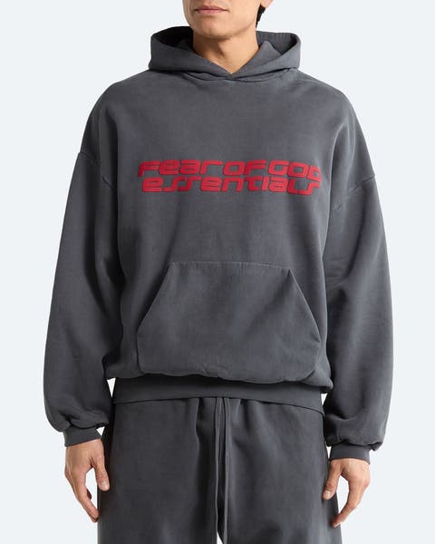 A man wearing a hoodie from Fear of God Essentials.