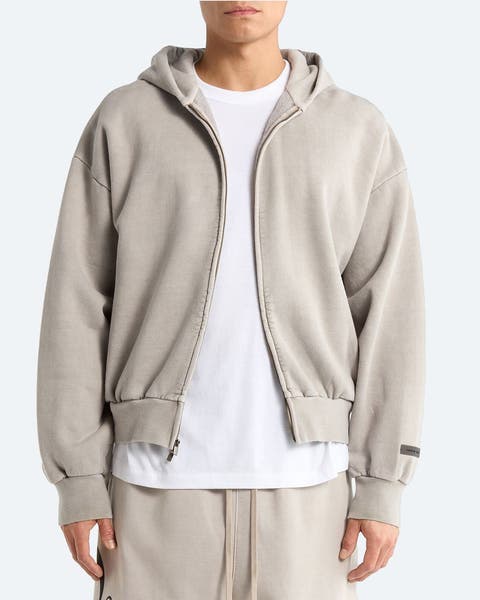 A man wearing a zip-front hoodie.