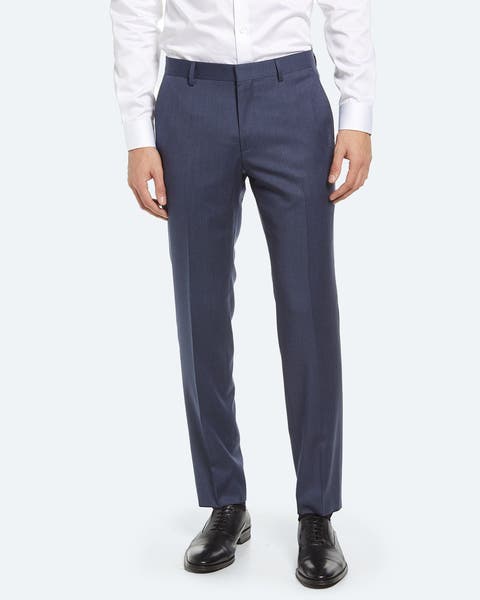 A man wearing navy blue dress pants.