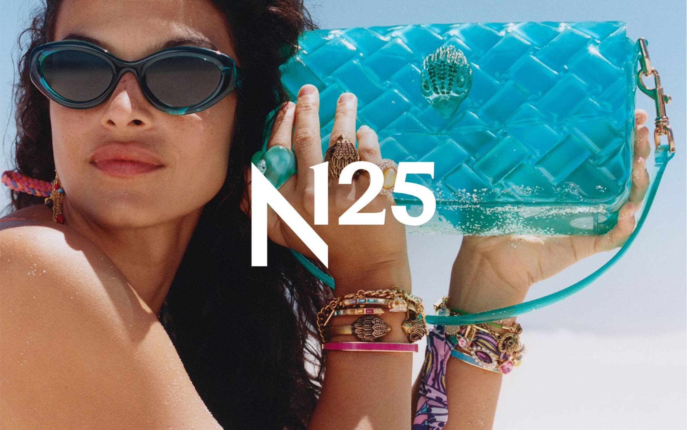 A woman on the beach holding a blue jelly bag.