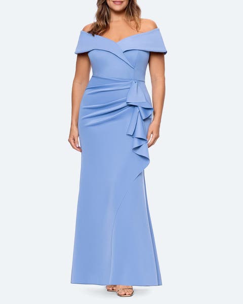 A woman wearing a light blue off-the-shoulder gown.  