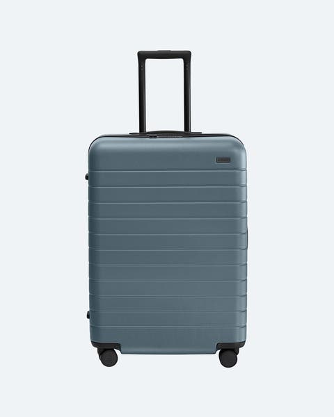 Blue roller suitcase.