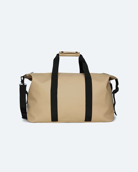 Beige duffle with black straps.
