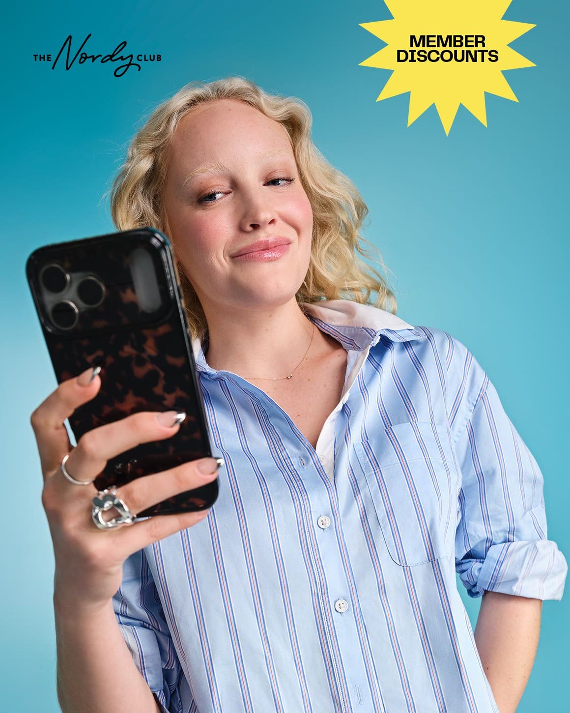 The Nordy Club: join today. A woman looking at her phone.
