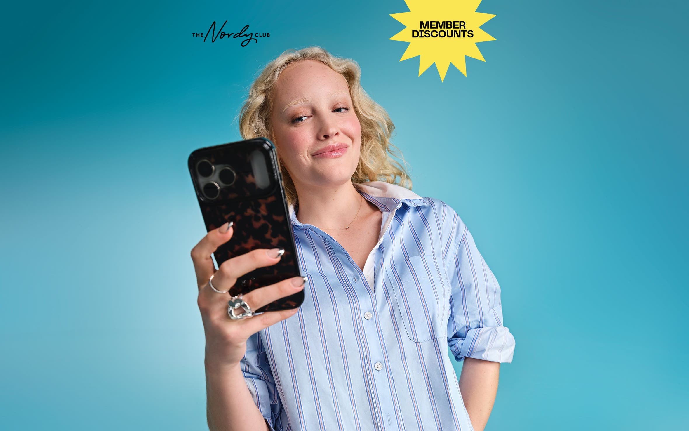The Nordy Club: join today. A woman looking at her phone.