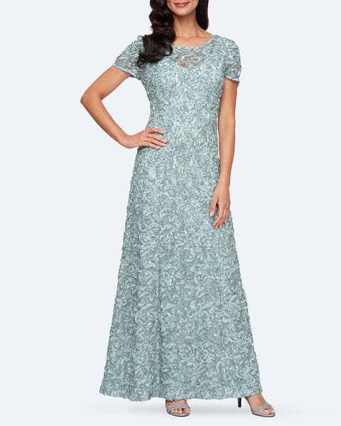 A woman wearing an embroidered pale blue gown.