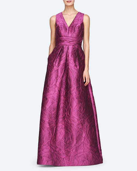 A woman wearing a pink crinkle satin gown.