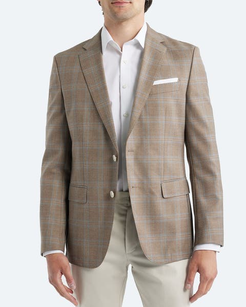 A man wearing a slim-fit sport coat.