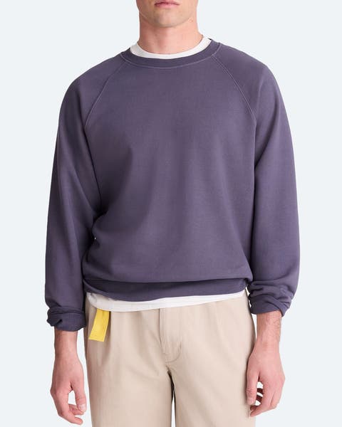 A man wearing a purple sweatshirt.