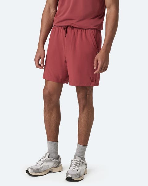A man wearing red athletic shorts.