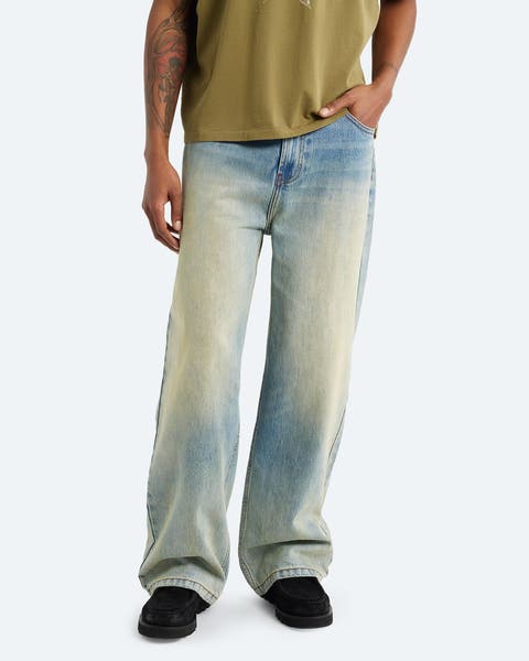 A man wearing faded jeans.