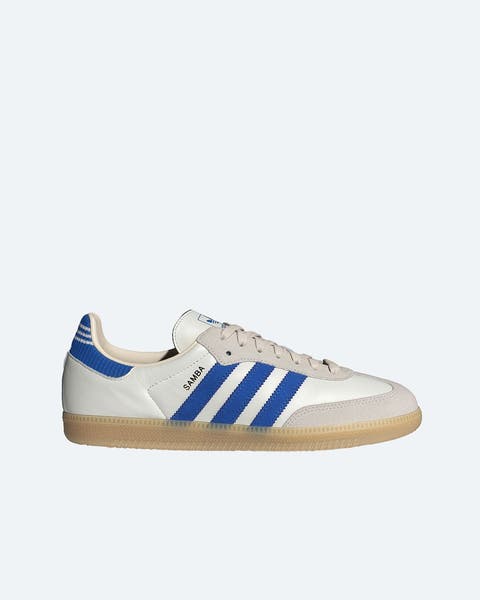 White adidas sneakers with blue stripes.