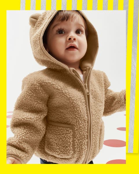 A baby in a fuzzy jacket.