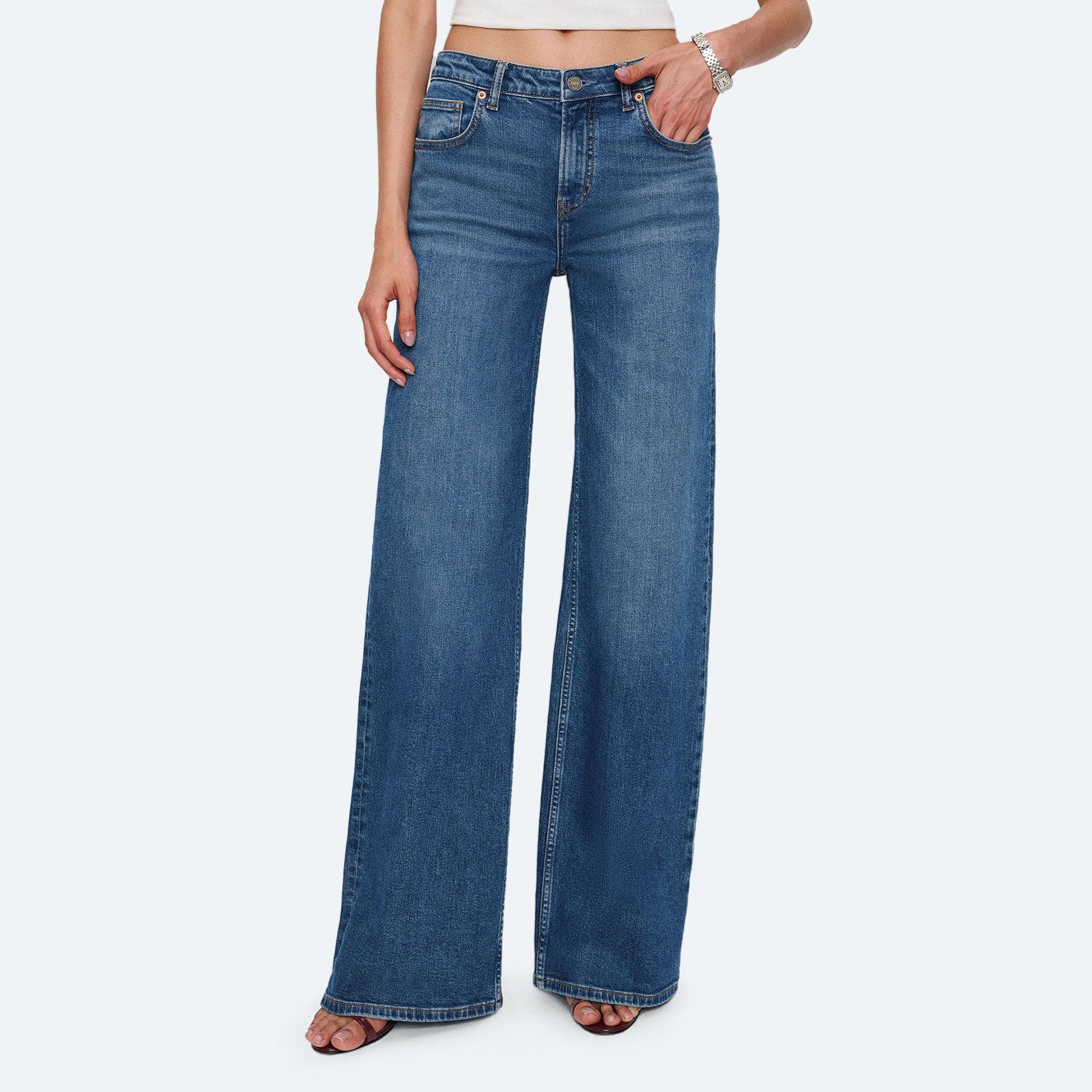 A pair of medium wash wide leg denim jeans.