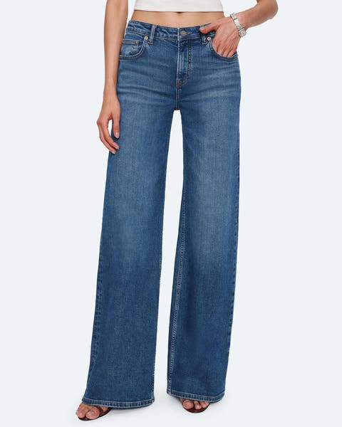 A pair of medium wash wide leg denim jeans.