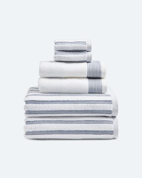 A set of white towels with blue stripes.