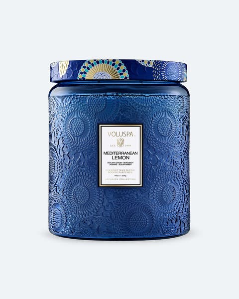 A blue Voluspa jar candle.