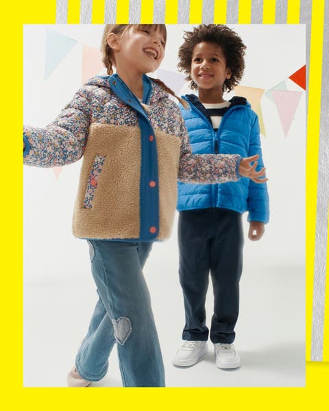 A girl and boy wearing jackets and jeans.