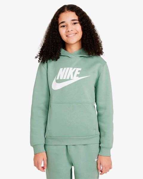 Young girl with curly hair wearing green activewear.