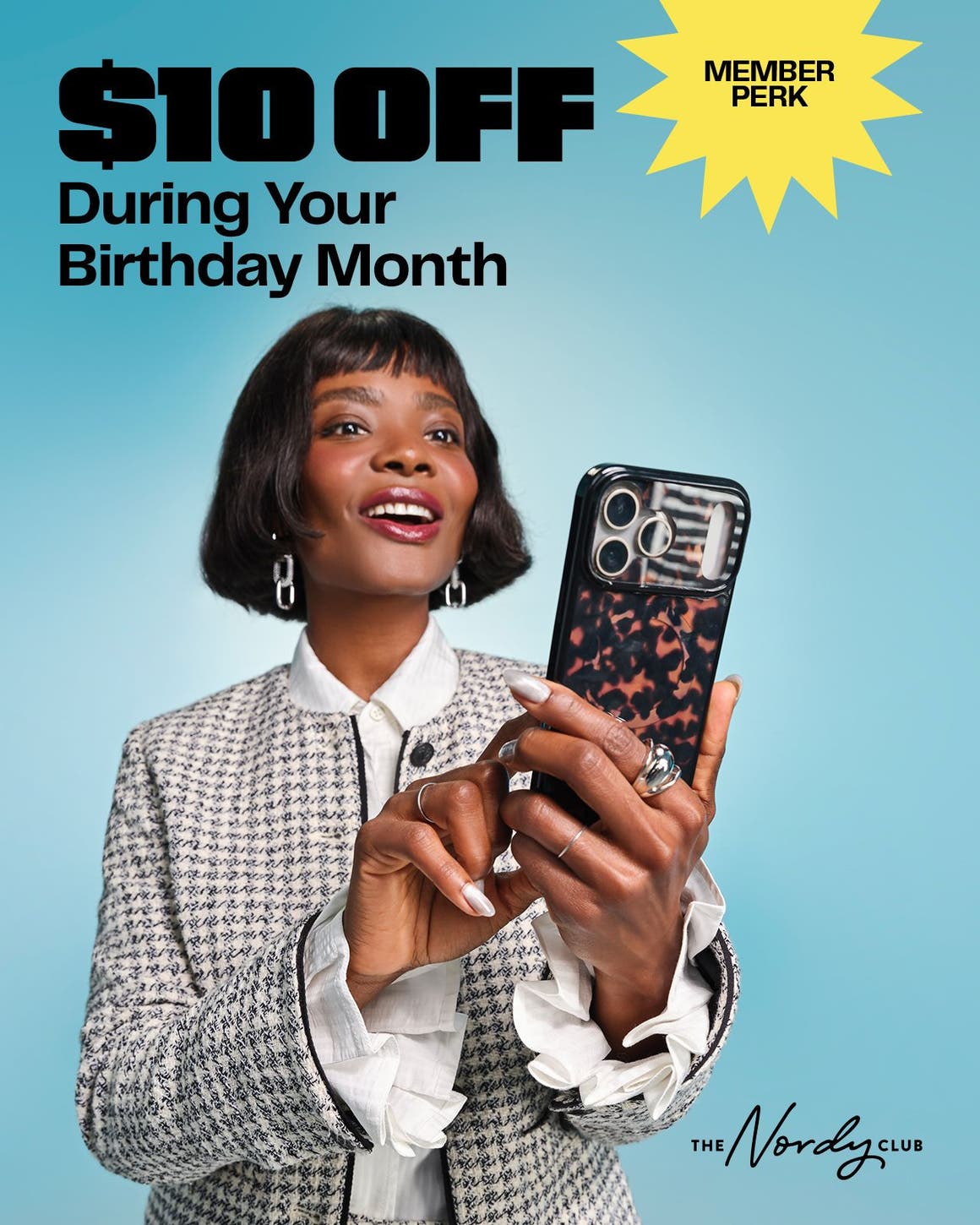 Member perk: get $10 off during your birthday month. A woman looking at her phone.