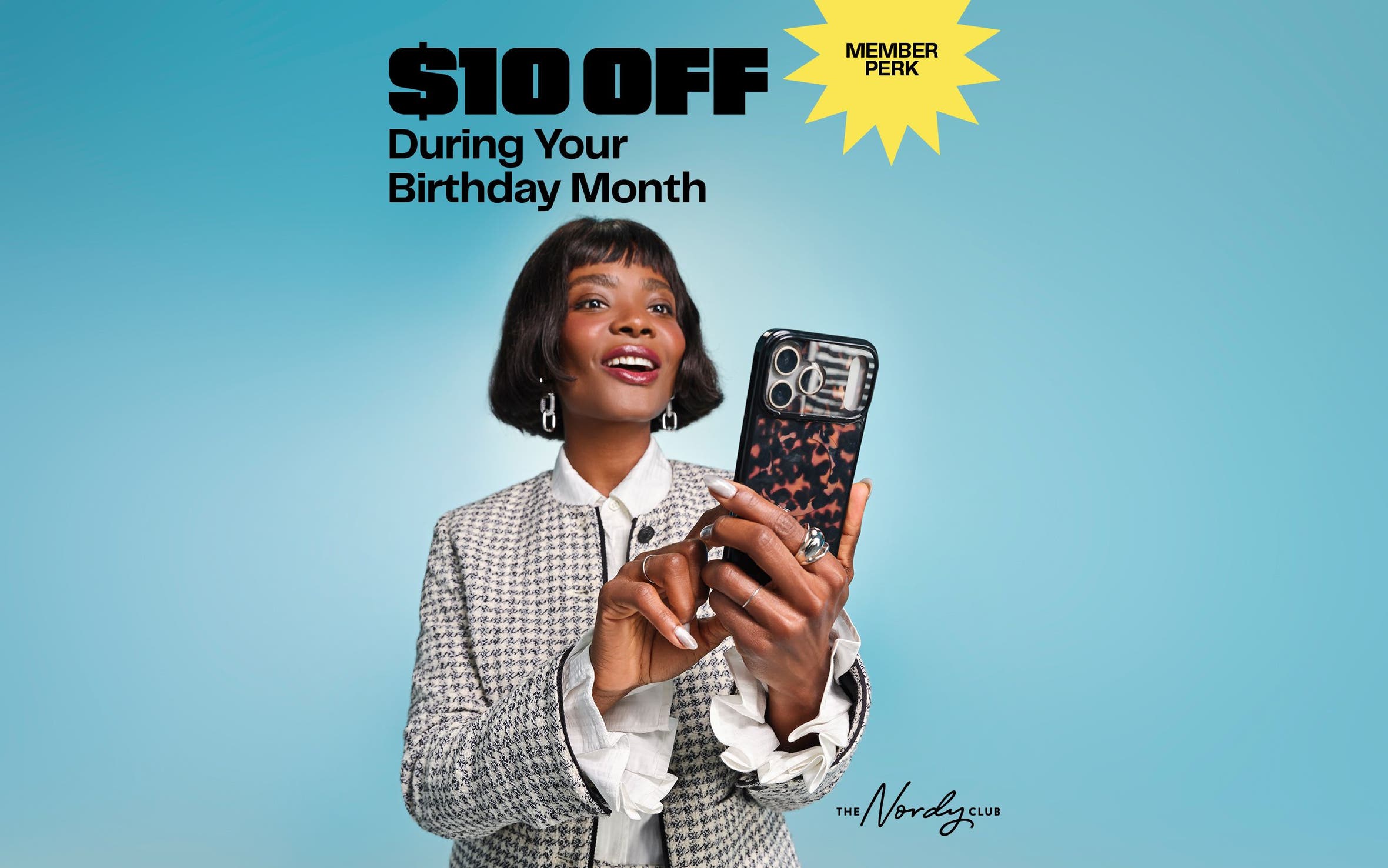 Member perk: get $10 off during your birthday month. A woman looking at her phone.