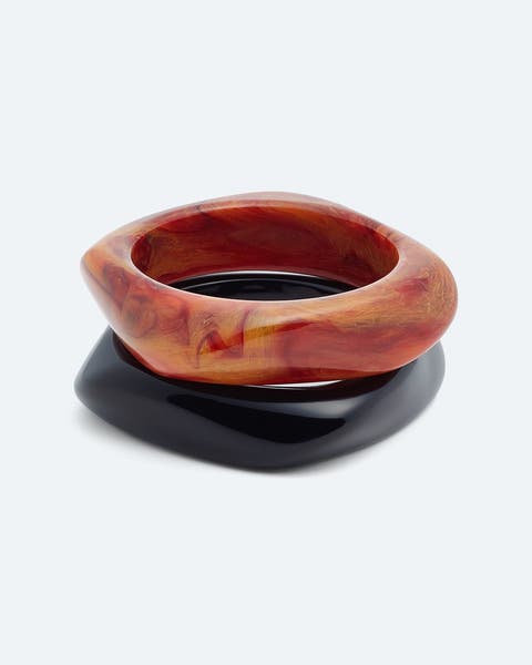 Orange marbled resin bangle stacked with a black bangle.