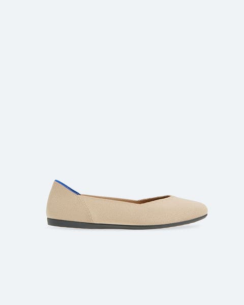 A pair of beige knit flats.