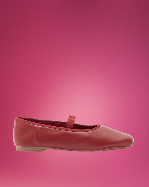 Red leather square-toe Mary Jane flat on pink.