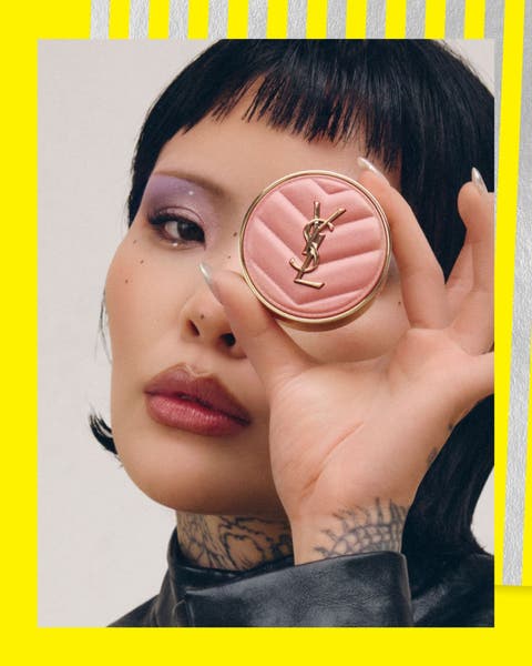 A woman holding blush.