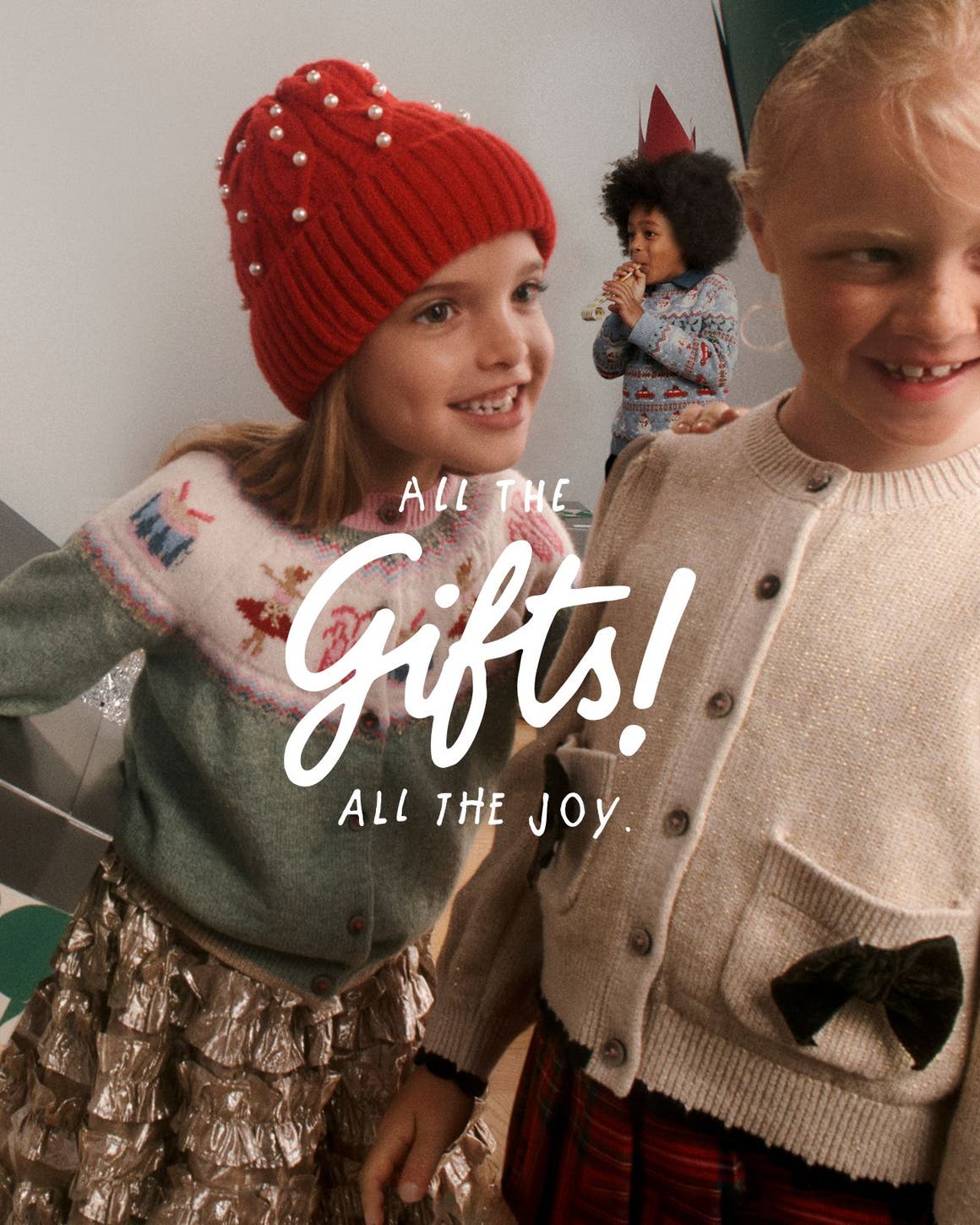 All the gifts! All the joy. Three kids celebrating.