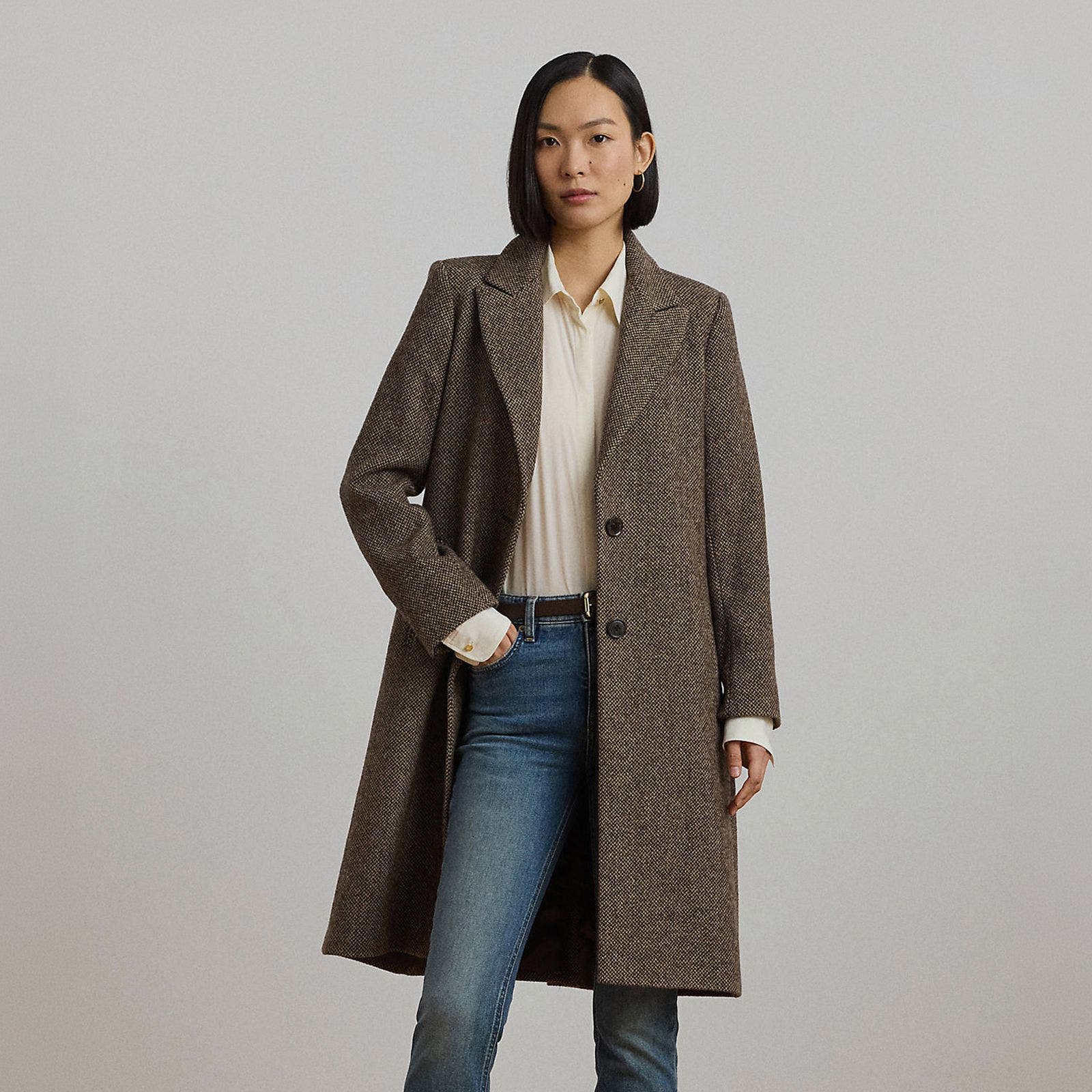 A woman in a brown tailored wool coat.