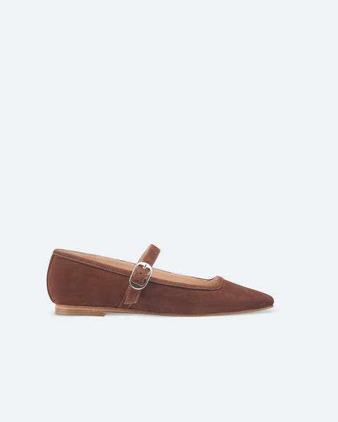 A pair of brown suede mary jane flats.