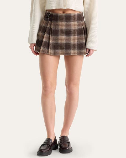 A woman wearing a plaid mini skirt.