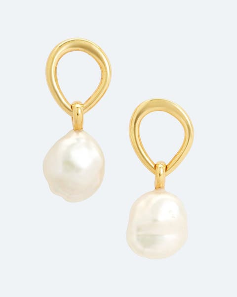 Gold teardrop earrings with a dangling baroque pearl.