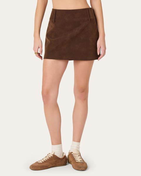 A woman wearing a brown suede mini skirt.