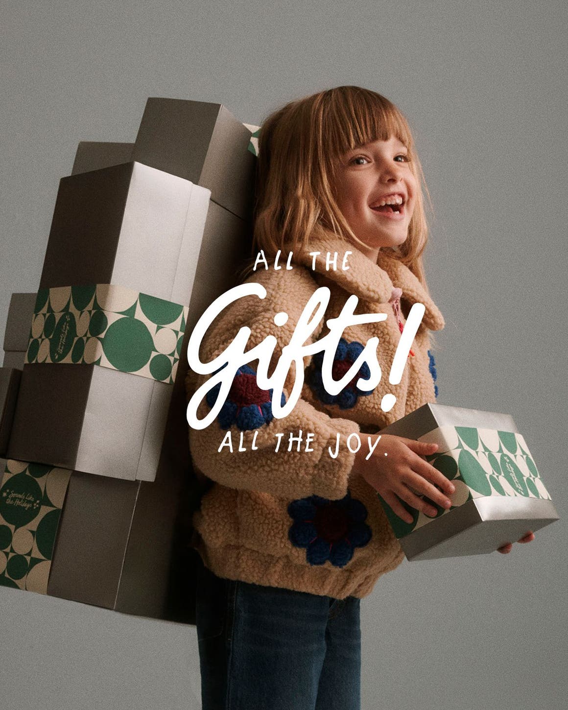 All the gifts, all the joy. A girl holding gifts.
