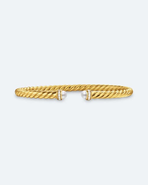 Gold cable cuff bracelet with pearl and pavé diamond end caps.