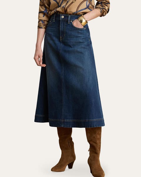 A woman wearing a long denim skirt.