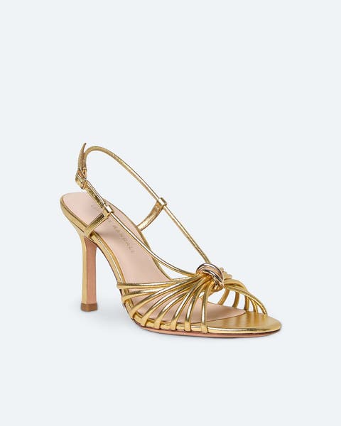 A gold, peep-toe shoe.