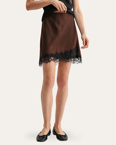 A woman wearing a brown lace-trimmed skirt.