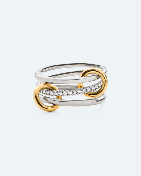 Two-tone gold and silver interlocking band ring with pavé diamond accent.