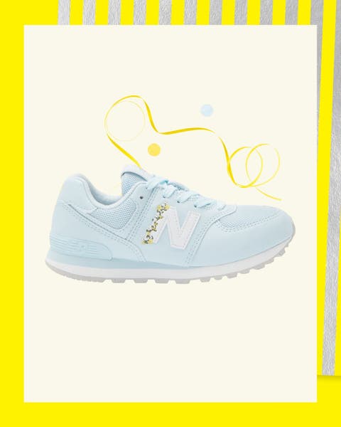 Blue New Balance sneakers with floral embroidery.