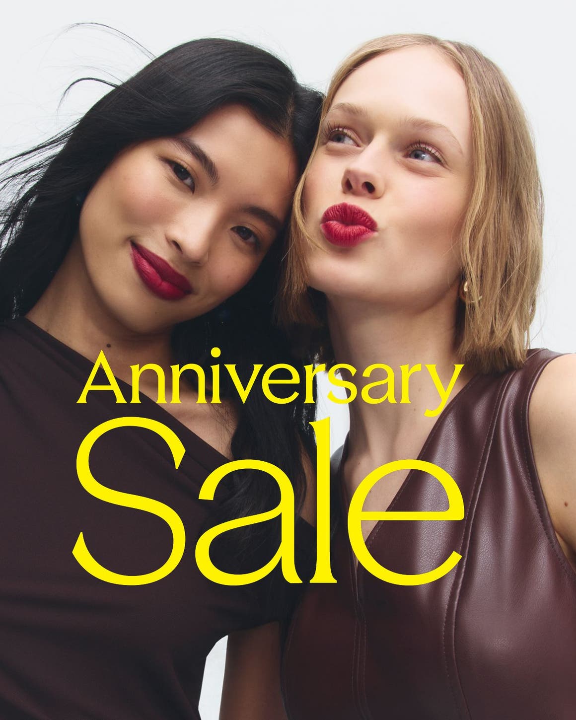 Anniversary Sale: two women in burgundy tops and berry lipstick. 