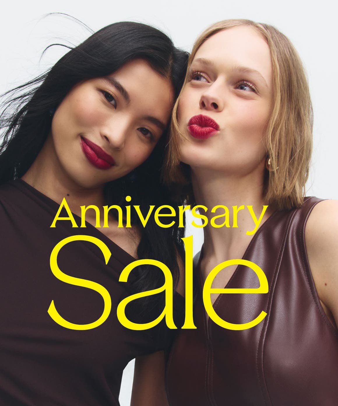 Anniversary Sale: two women in burgundy tops and berry lipstick. 