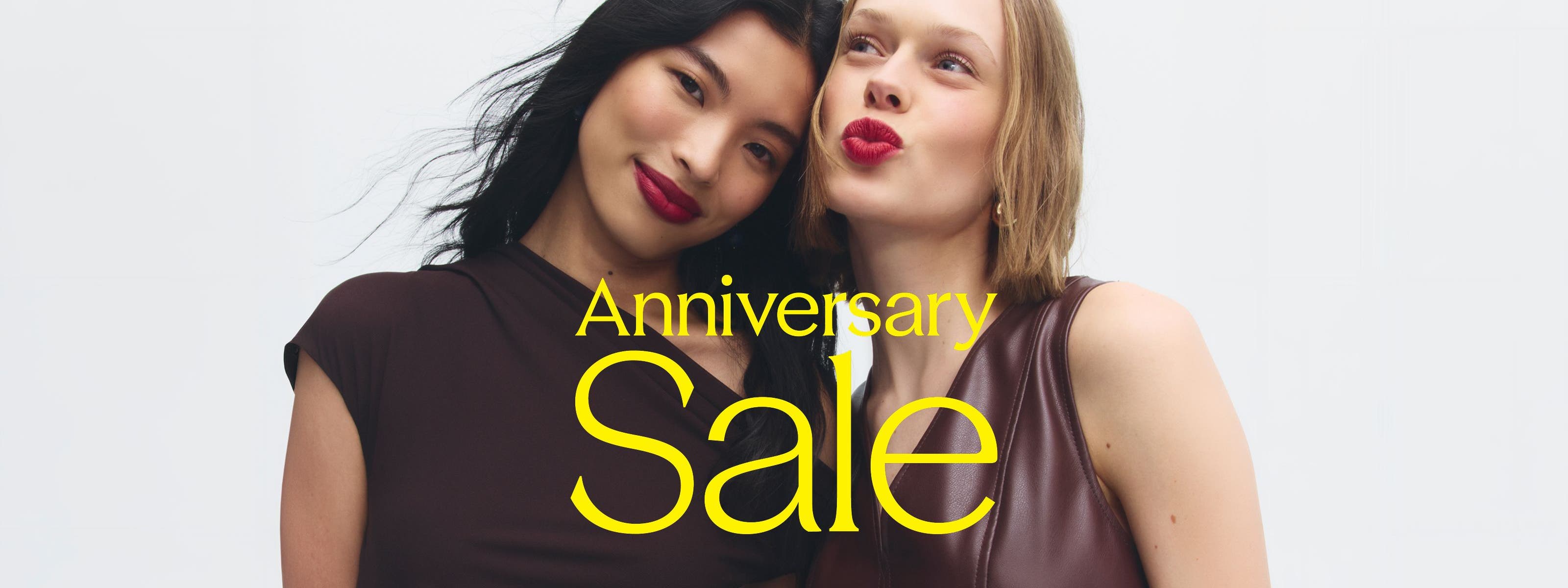 Anniversary Sale: two women in burgundy tops and berry lipstick. 