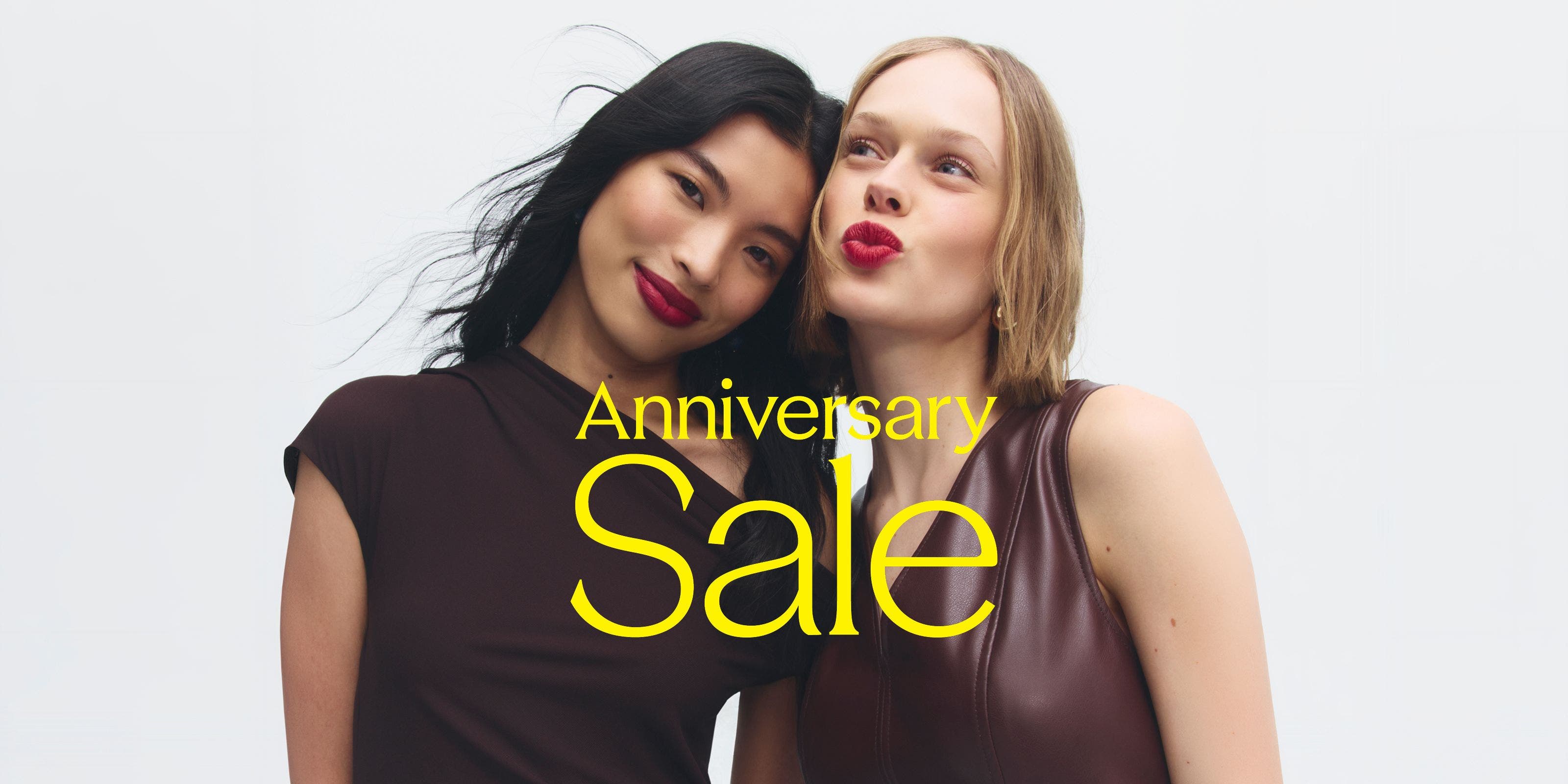 Anniversary Sale: two women in burgundy tops and berry lipstick. 
