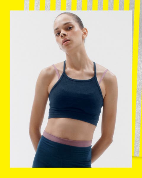 A woman wearing a sports bra and matching leggings.