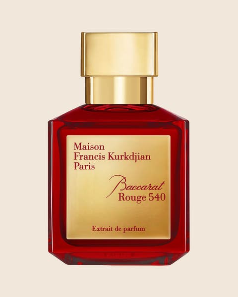 A Maison Francis Kurkdjian Baccarat Rouge 540 extrait de parfum in a red glass bottle with a gold cap.