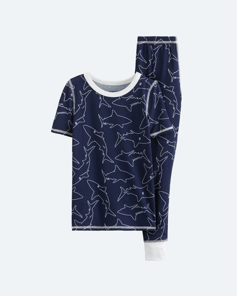 A navy blue pajama set with sharks for little boys.